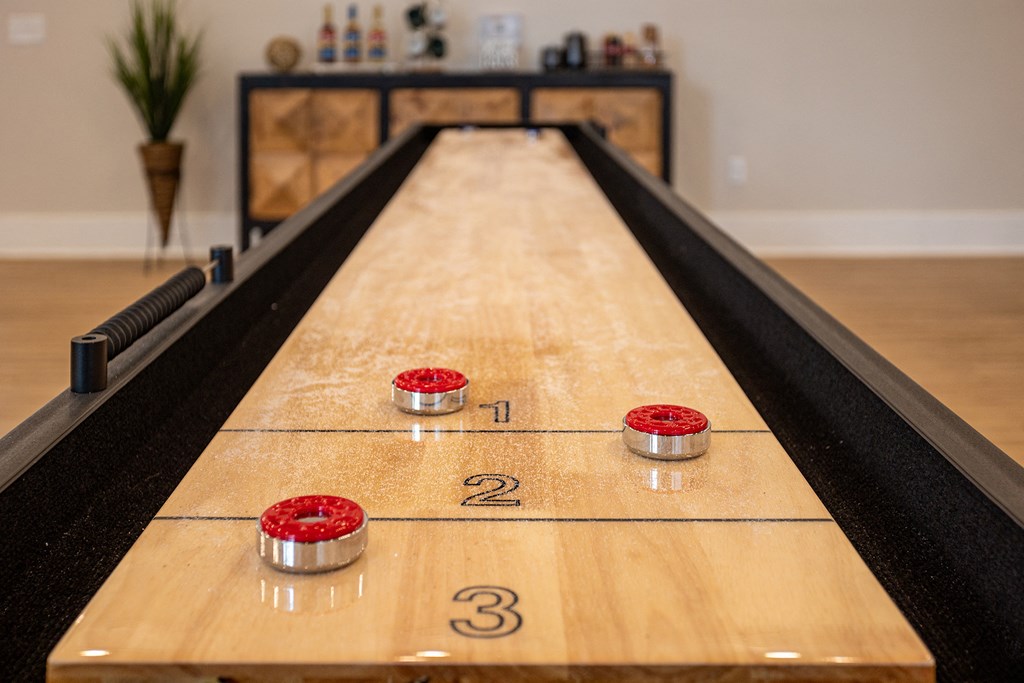 a shuffleboard table in a game room