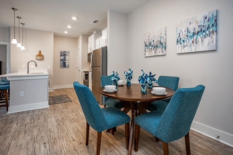 a dining room with blue chairs and a wooden table