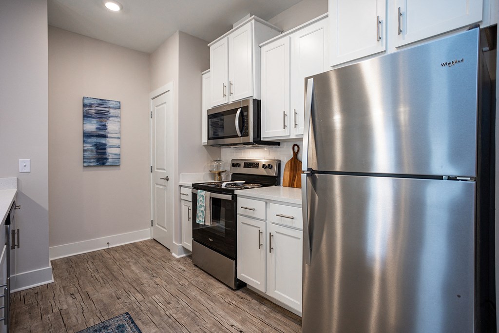a kitchen with stainless steel appliances and white cabinets