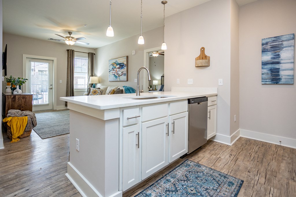 an open kitchen with a sink and a dishwasher in a home