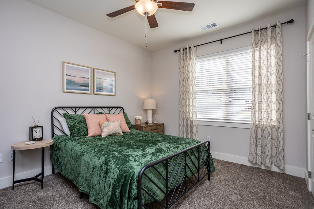 a bedroom with a bed and a ceiling fan