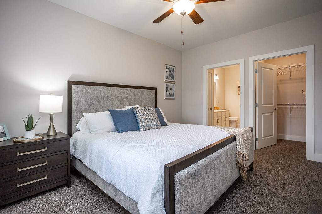 a bedroom with a large bed and a ceiling fan