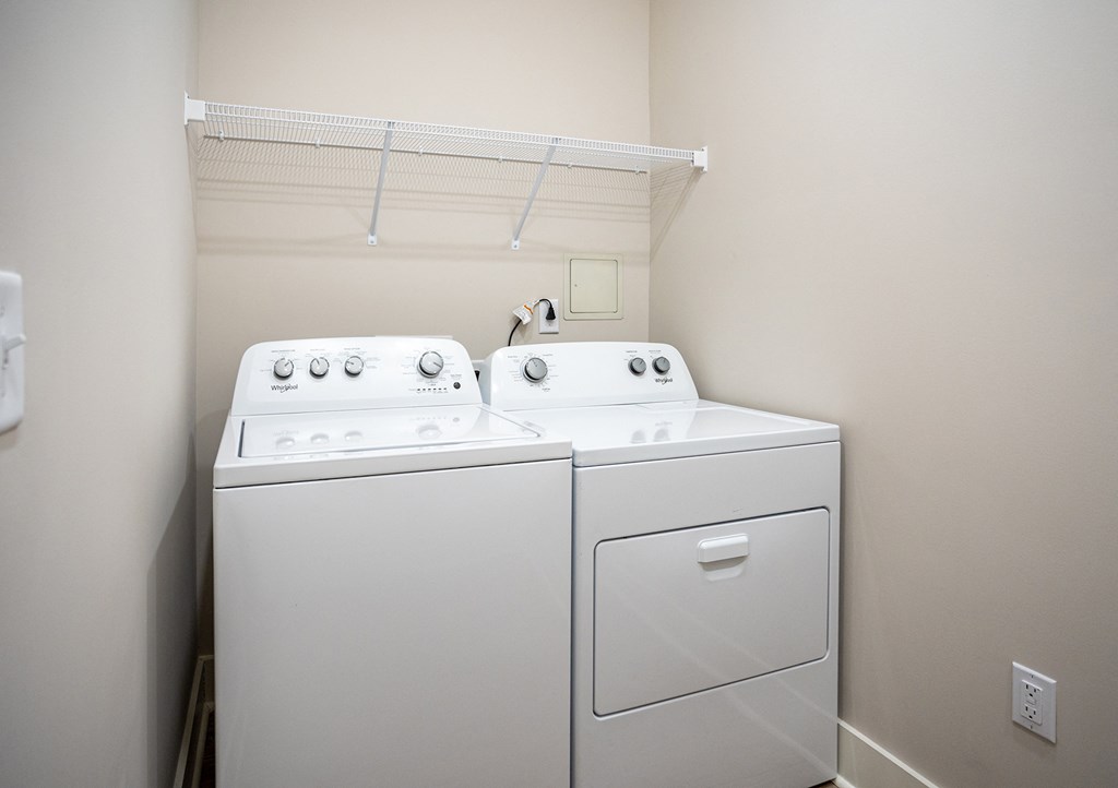 a white washer and dryer in a room with a white wall and ceiling