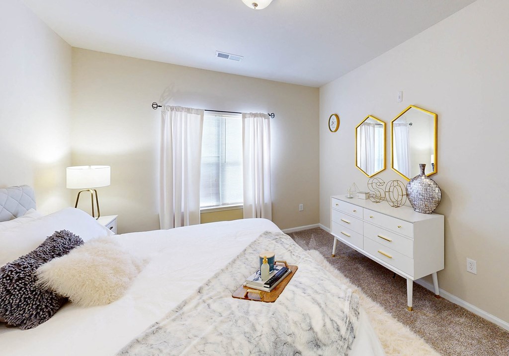 a bedroom with a bed and a dresser