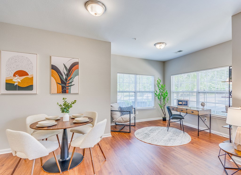 an open living room with a dining room table and chairs