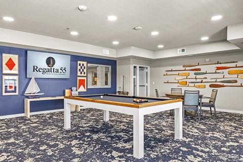 A room with a pool table and a sign that says Regatta 55.