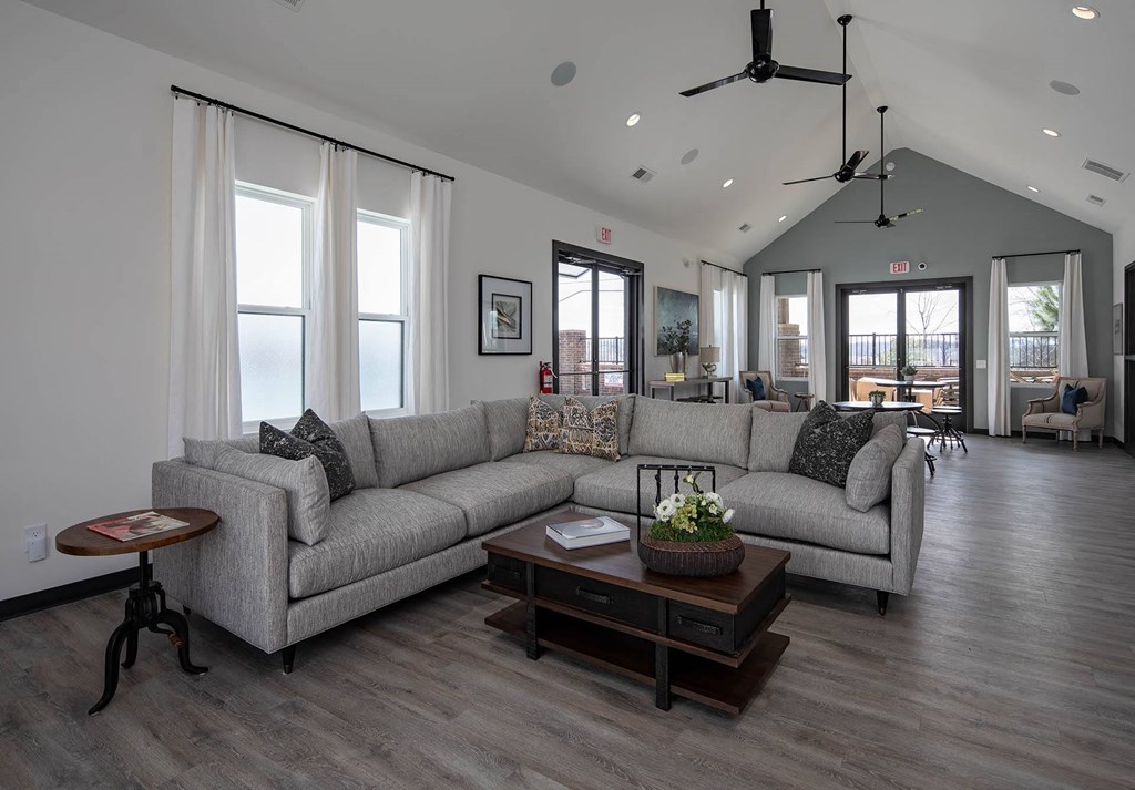 a living room filled with furniture and a large window