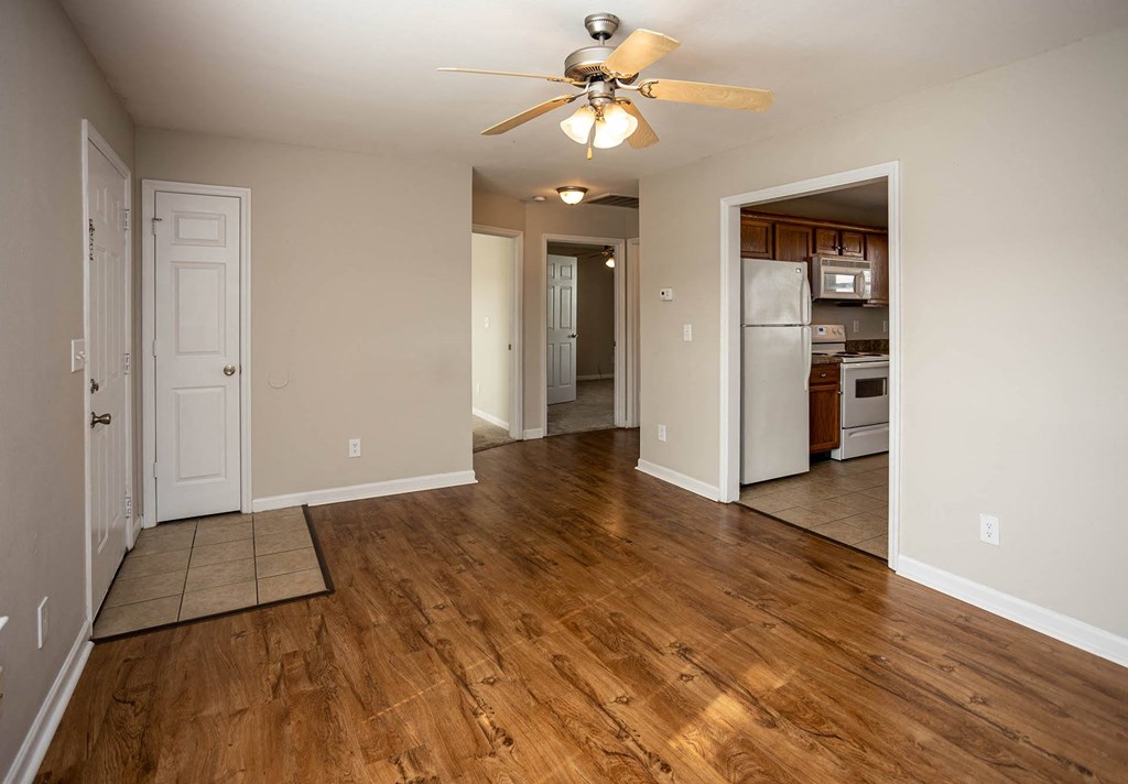 a living room with hardwood floors and a ceiling fan