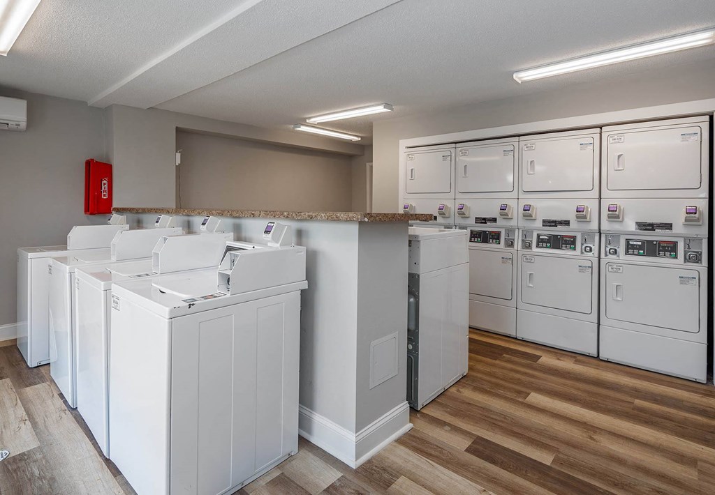 a laundry room with washers and dryers