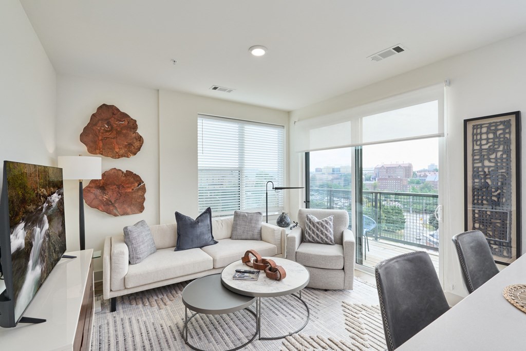 a living room with a couch and chairs and a table