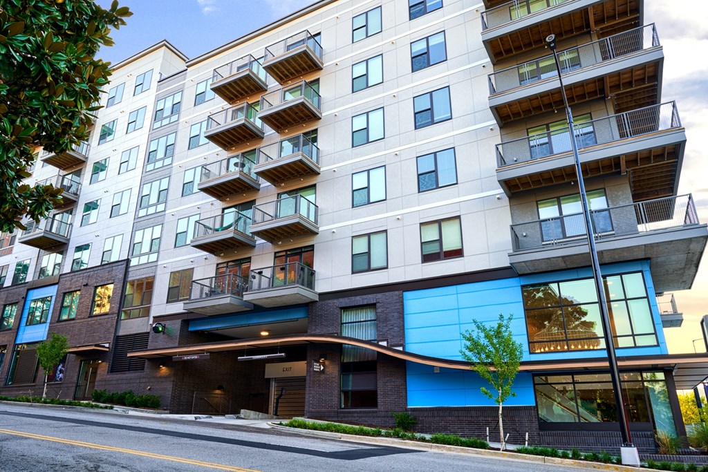 a large apartment building with a street in front of it