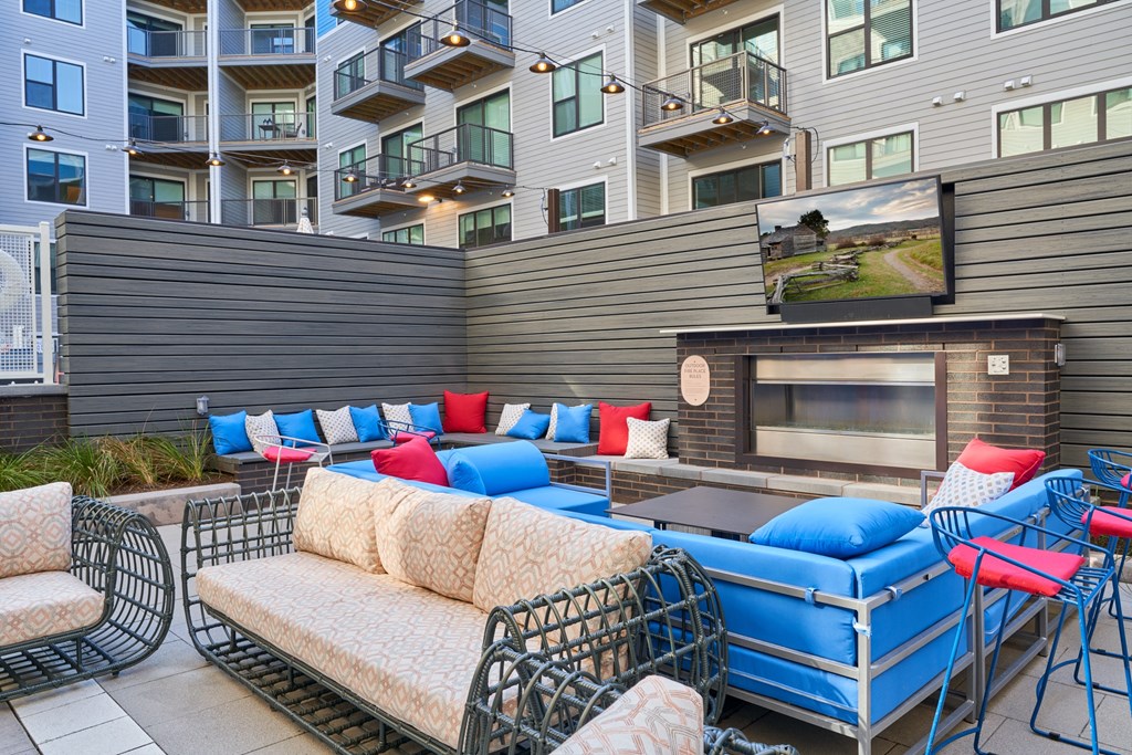 a lounge area with couches and chairs and a fireplace