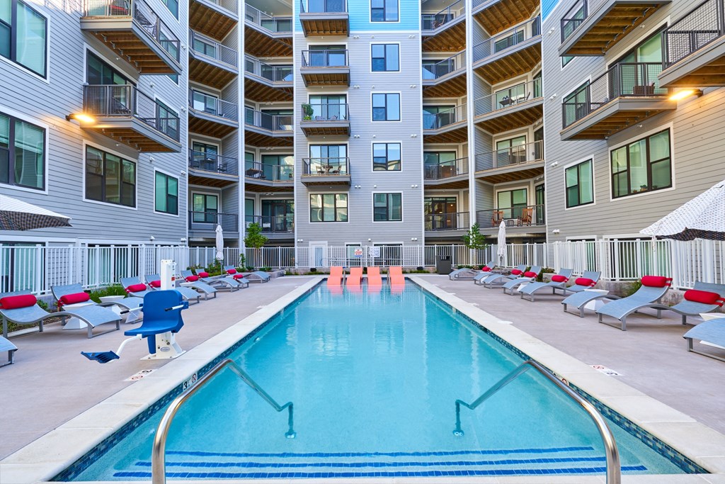 a swimming pool in front of an apartment building
