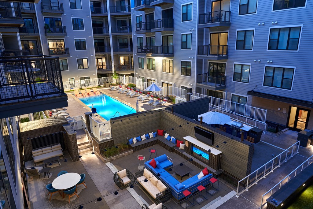 an overhead view of an apartment complex with a pool