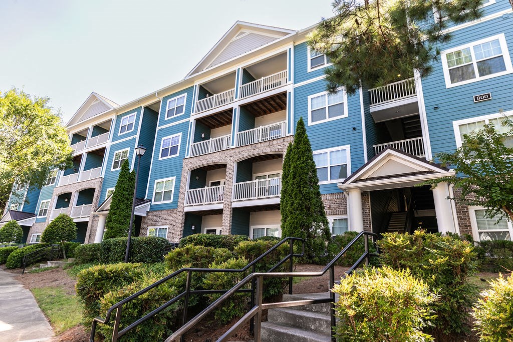 an apartment building with stairs in front of it