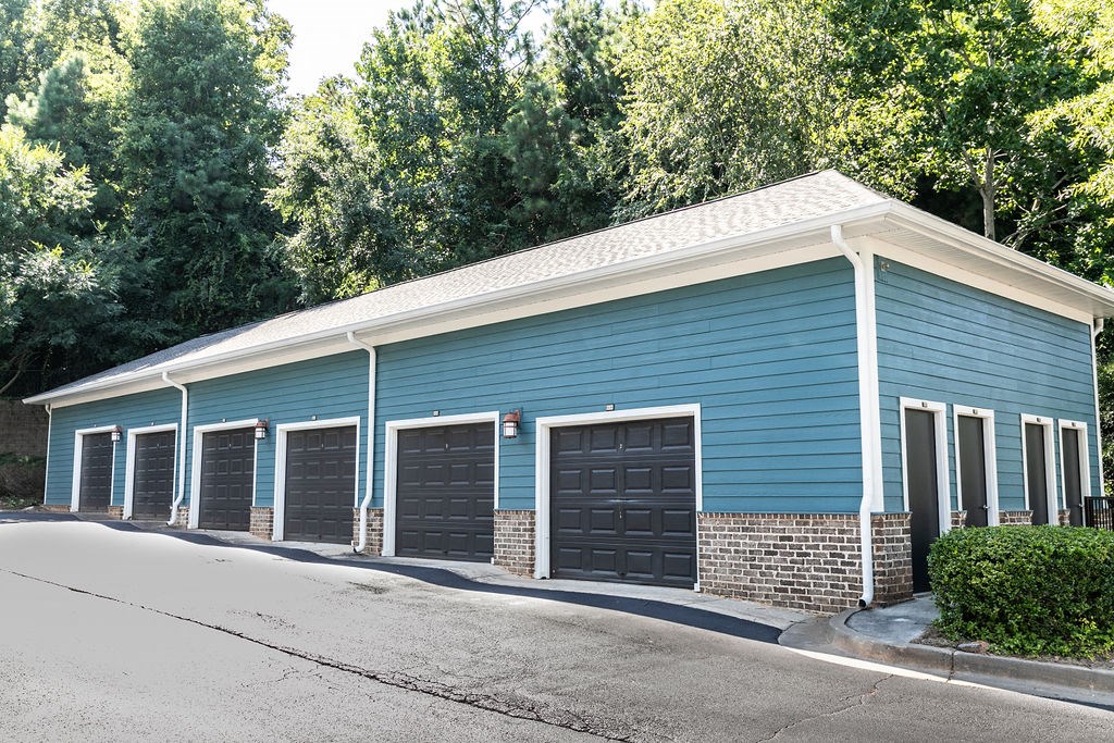 a blue building with a row of garage doors