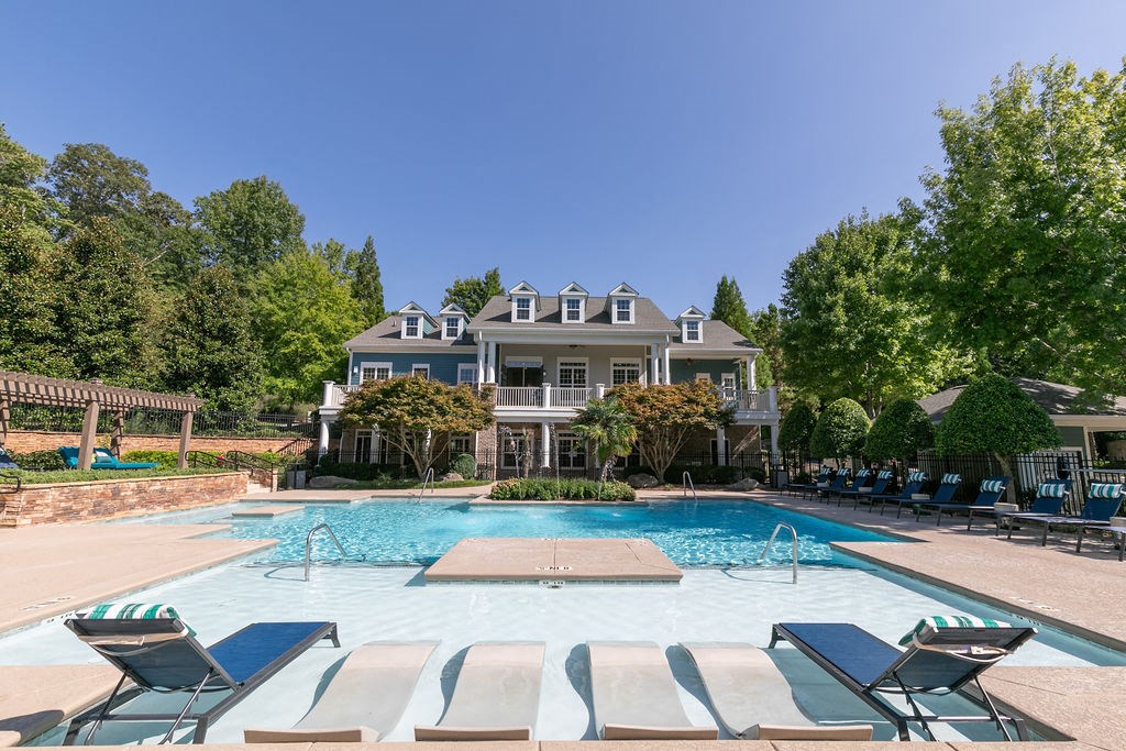 Apartments in Newnan, GA, with In-Unit Washer and Dryer - The Jackson - Swimming Pool with a Sundeck, In-Water Loungers, Lounge Chairs, and Cabanas.