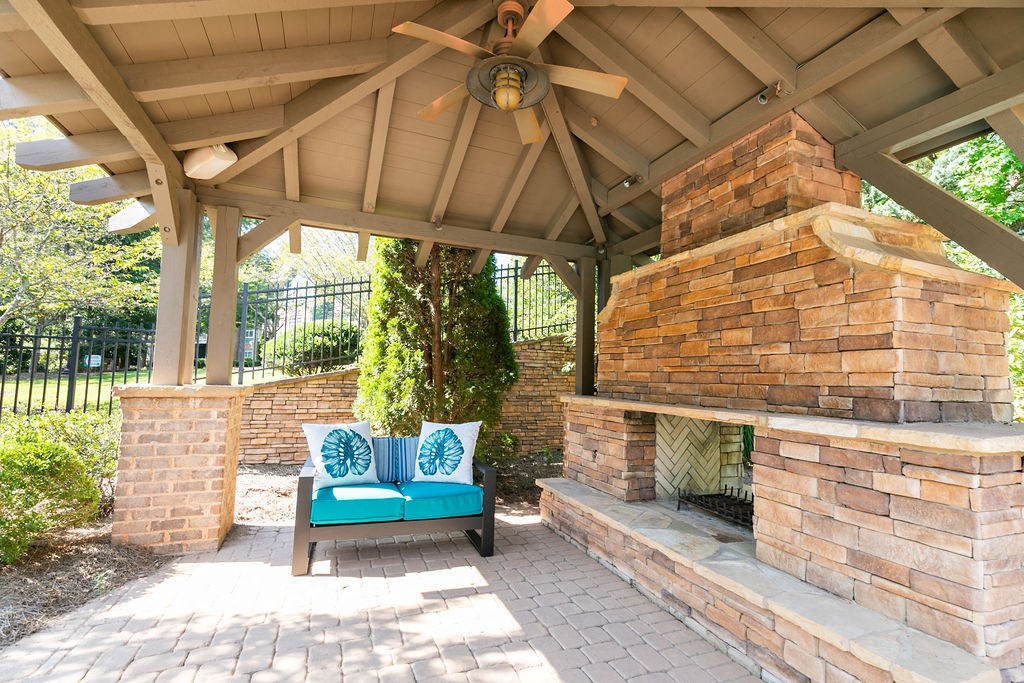 a patio with a bench and a gazebo