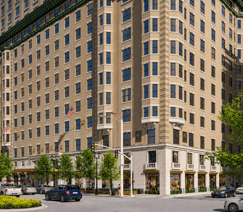 A large beige building with a lot of windows and a sign that says "MC" on it.