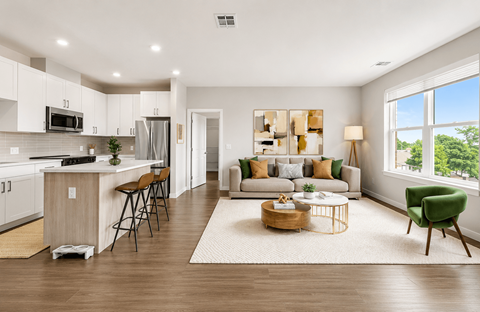 A modern kitchen with a bar stool and a dining table.