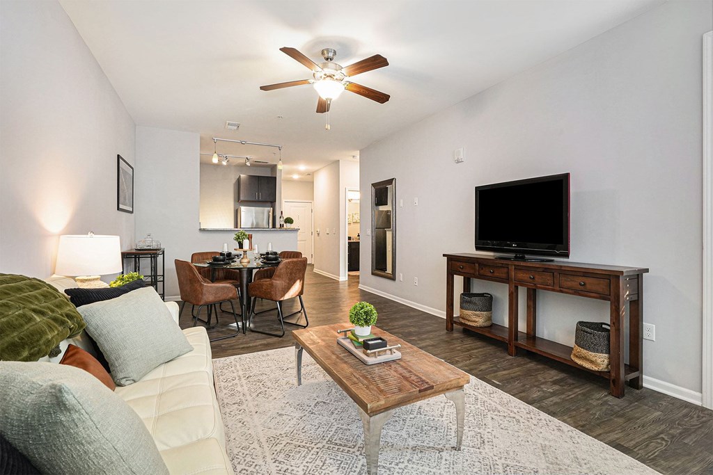 A living room with a couch, a coffee table, and a television.