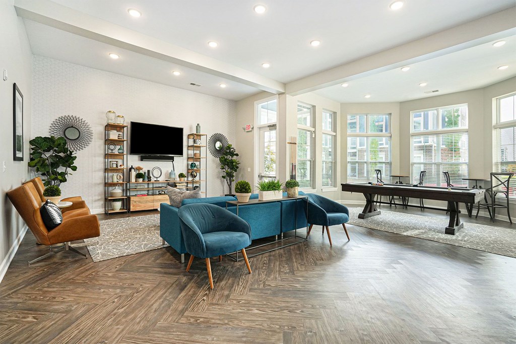 A living room with a blue chair in the center.