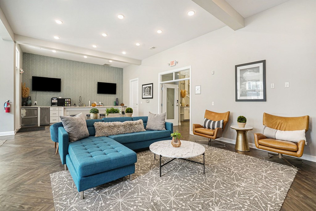 A living room with a blue couch and a coffee table.