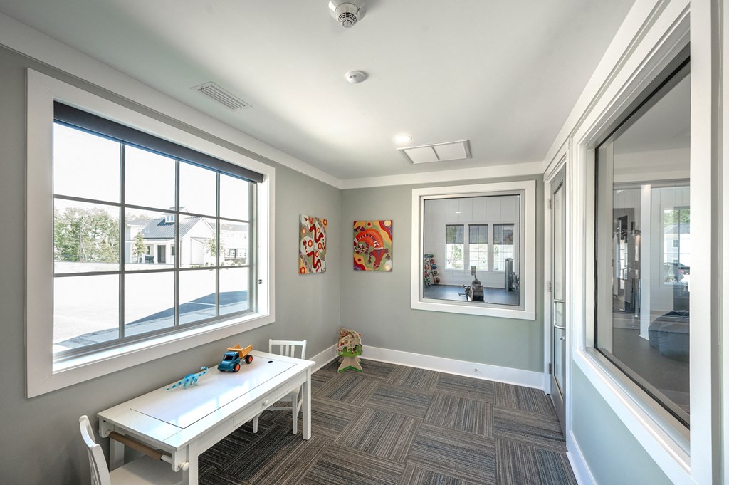 a conference room with a white table and a large window
