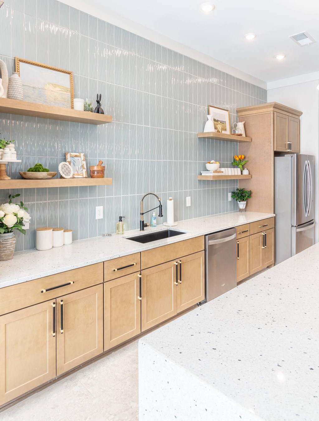 a modern kitchen with wooden cabinets and stainless steel appliances
