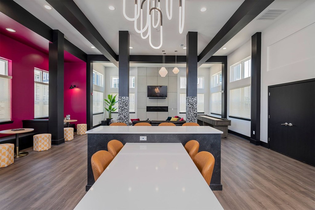 A modern dining room with a long table and chairs.
