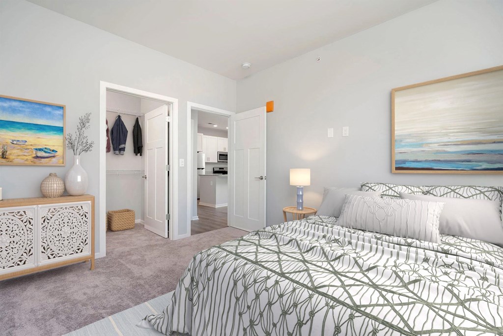 A bedroom with a large bed and a painting on the wall.