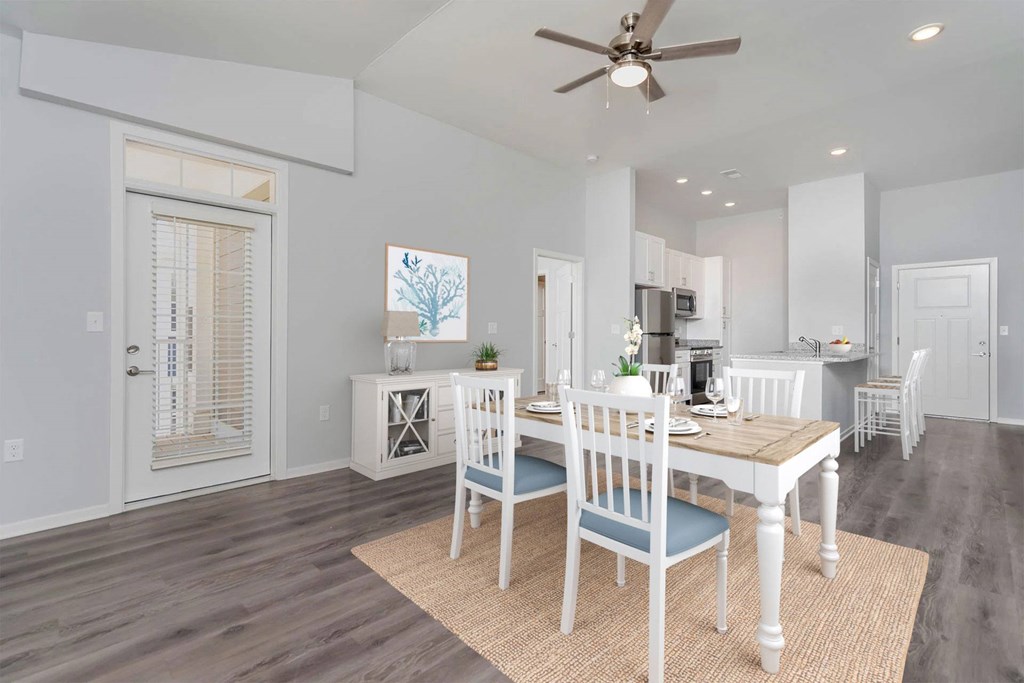 A dining room with a table set for four.