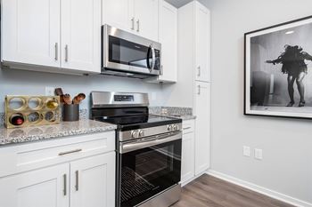 A modern kitchen with a stainless steel oven and microwave.