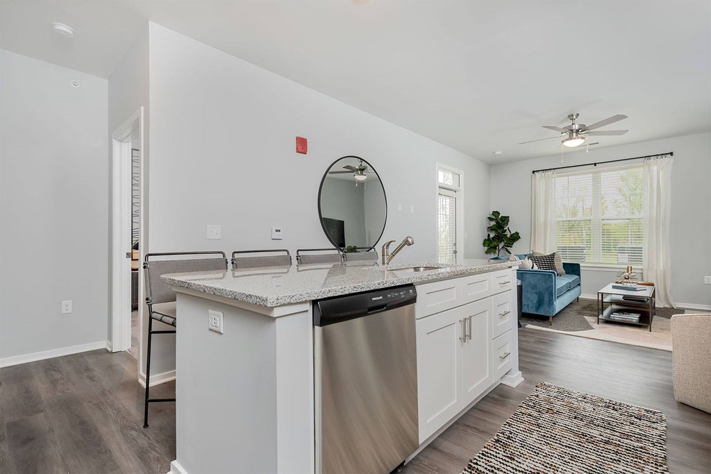 A modern kitchen with white cabinets and a large island.