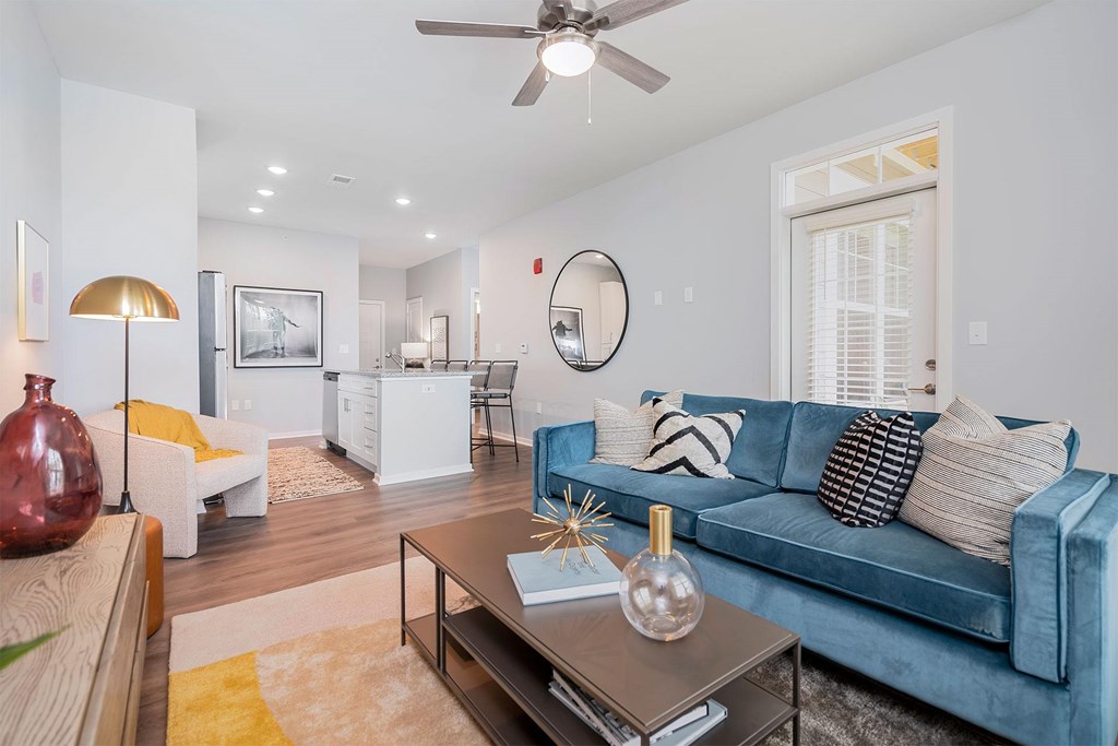 A living room with a blue couch and a coffee table.