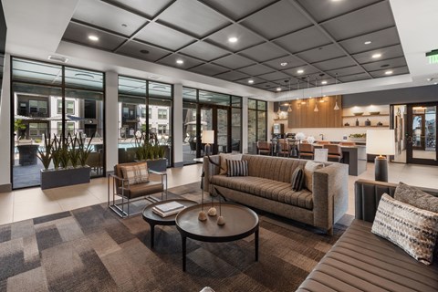 A modern living room with a brown sofa and a coffee table.