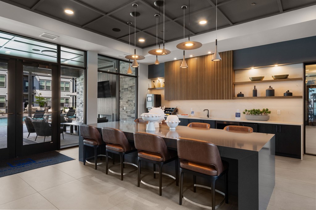 A modern kitchen with a bar area and a dining table.