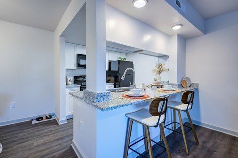A kitchen with a blue countertop and white walls L'Estancia, Sarasota, FL, 34231