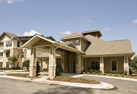 A large, well-maintained house with a spacious front yard.
