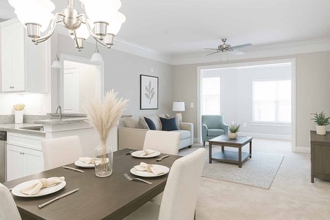 A dining room with a table set for a meal.