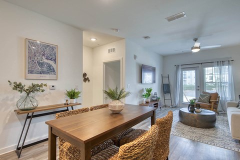 A dining room with a wooden table and chairs.