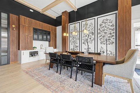 A dining room with a table set for four.