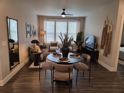 A dining room with a round table and chairs.