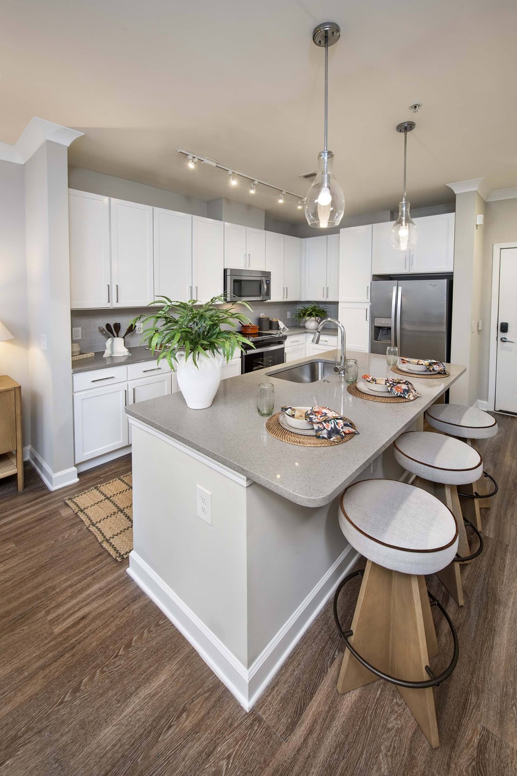 A kitchen with a large island and bar stools.