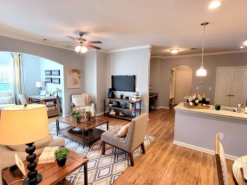a living room and dining room with a couch and a tv