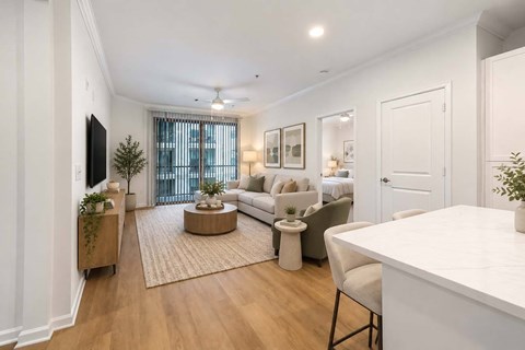 A living room with a white couch, a white table, and a white chair.