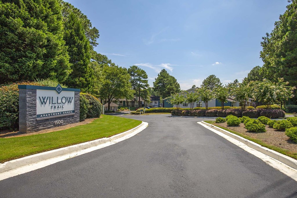 A road leading to a sign that says Willow.