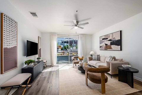A living room with a brown chair and a white couch.