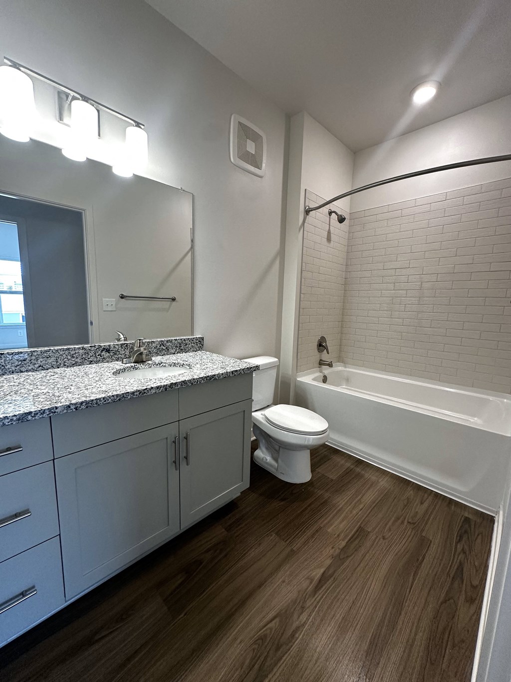 a bathroom with a toilet and a tub and a sink