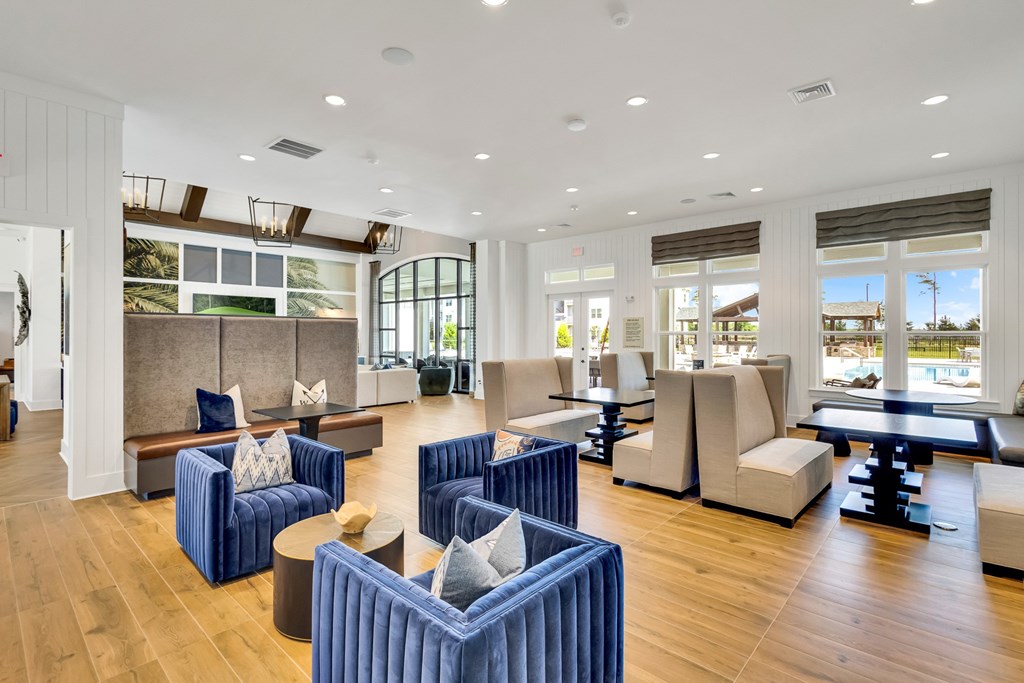 A large, modern living room with blue and beige furniture.